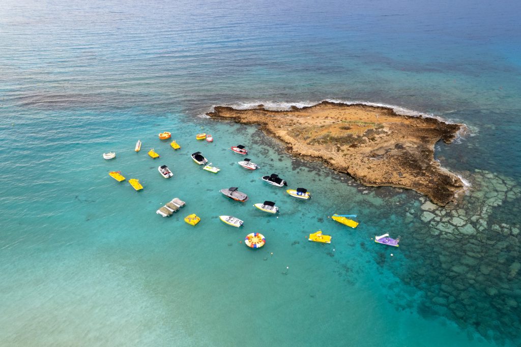 Aerial drone photograph of watersport boats moored anchored at the sea. Summer holidays